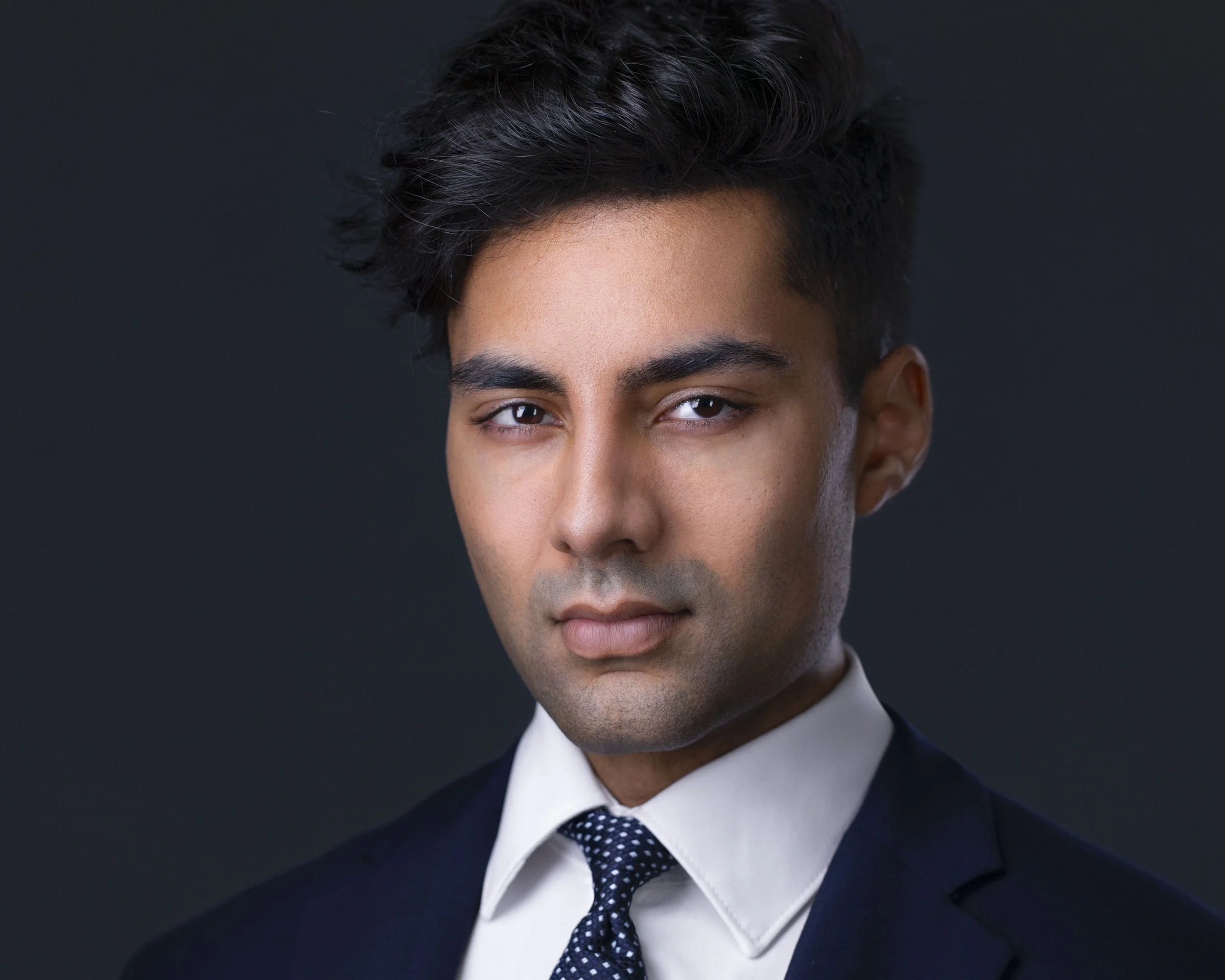 Professional executive headshot of business leader with natural expression photographed by executive headshot photographer Dallas in corporate headshots studio