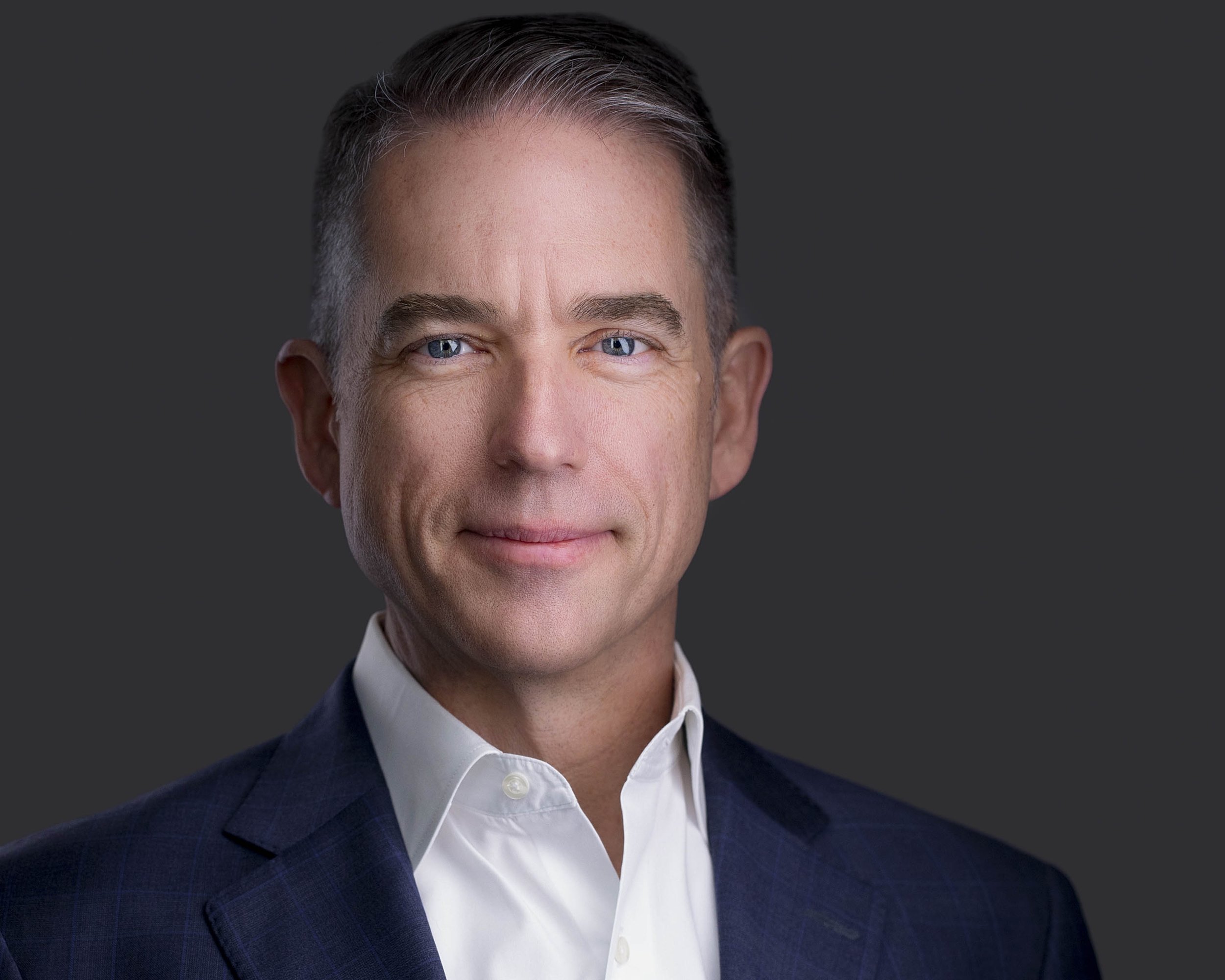 Male executive in navy jacket photographed for professional headshots in Dallas TX.