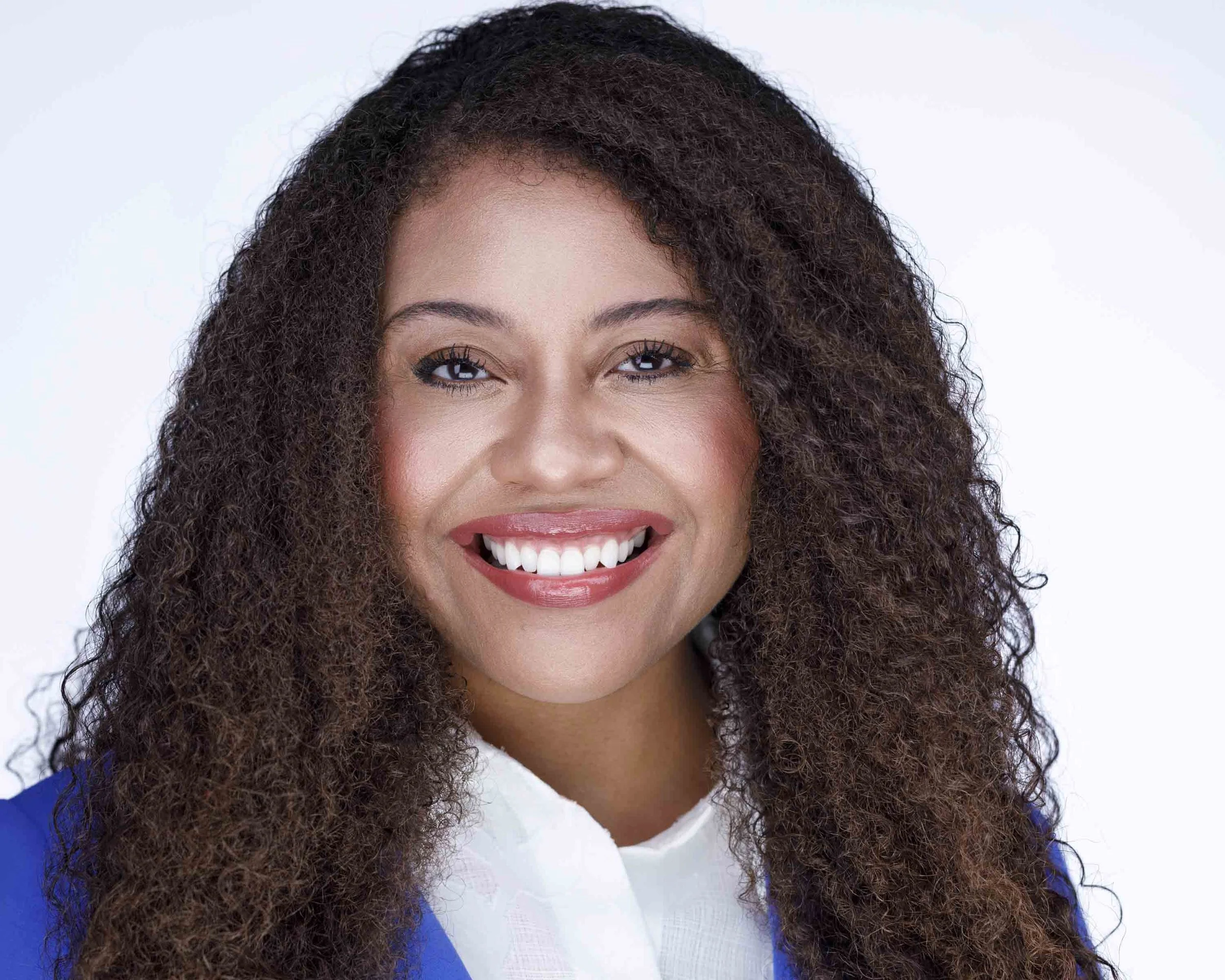 A bright, confident corporate headshot captured at Godoy Shots Studio in Dallas, TX. This image features a polished, approachable smile and natural expression, perfect for LinkedIn, company profiles, and professional branding. The clean white backgro