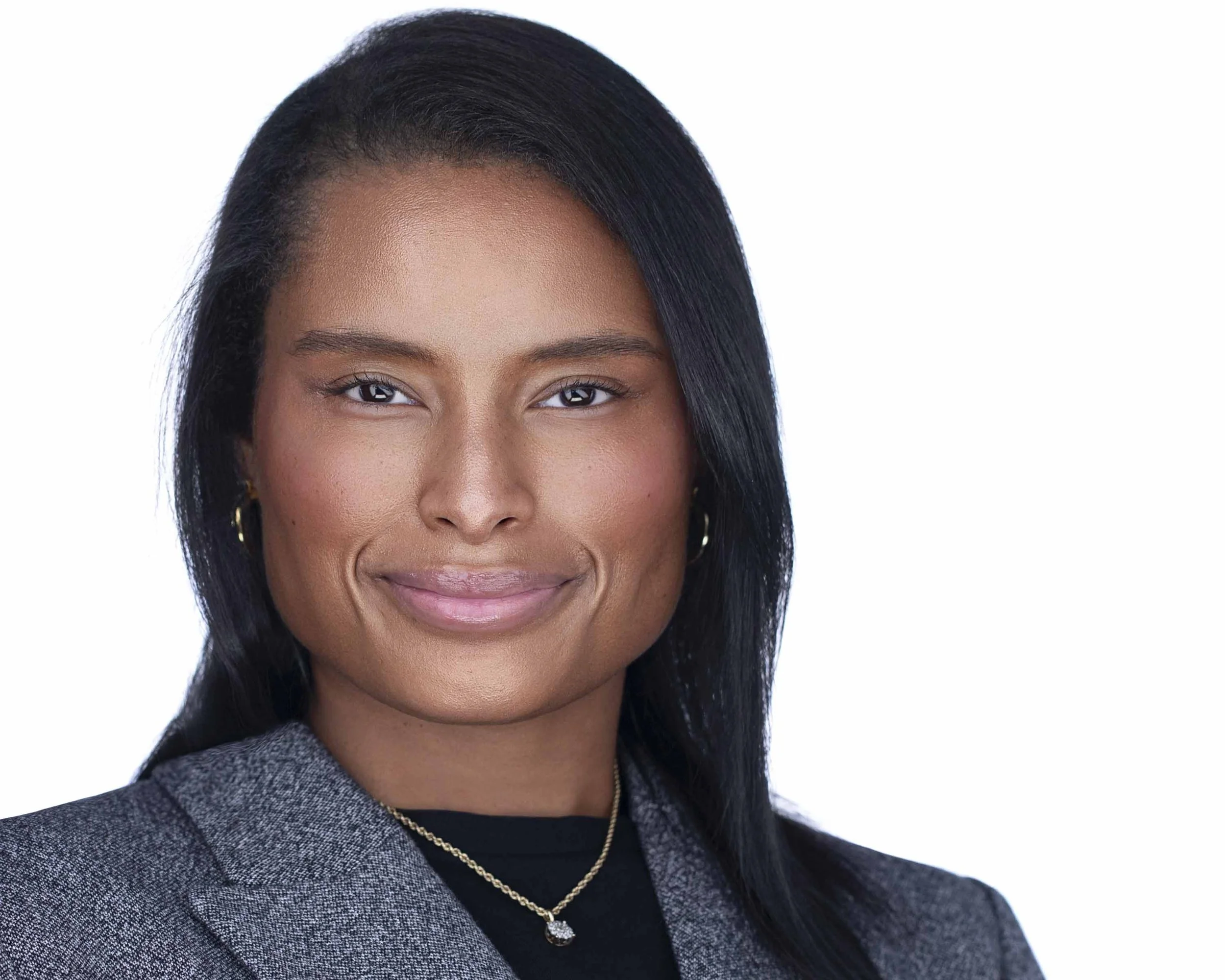 Female business leader in gray blazer photographed for corporate headshots in Dallas TX.