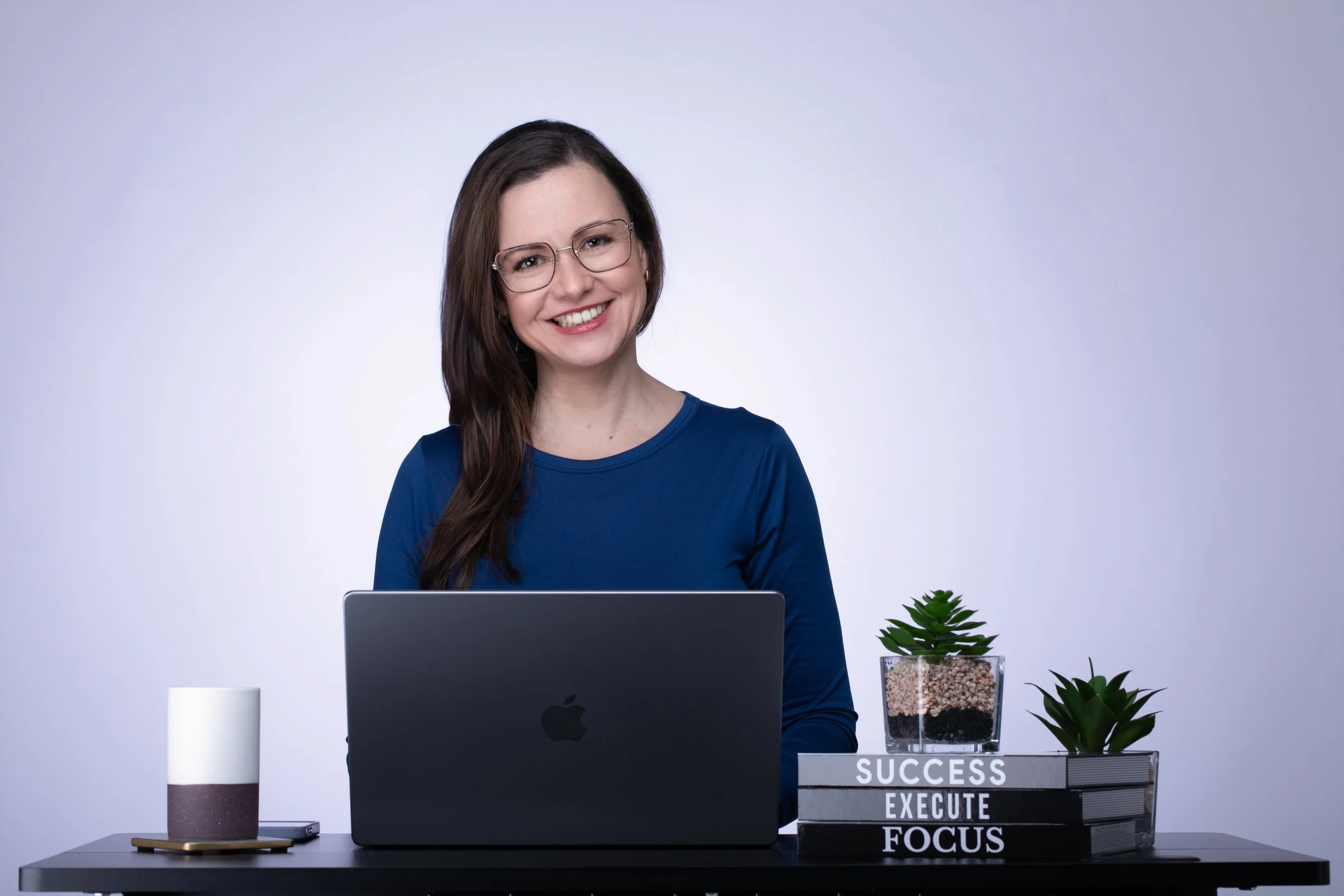 Laura Godoy managing client communication at Godoy Shots studio in Dallas.