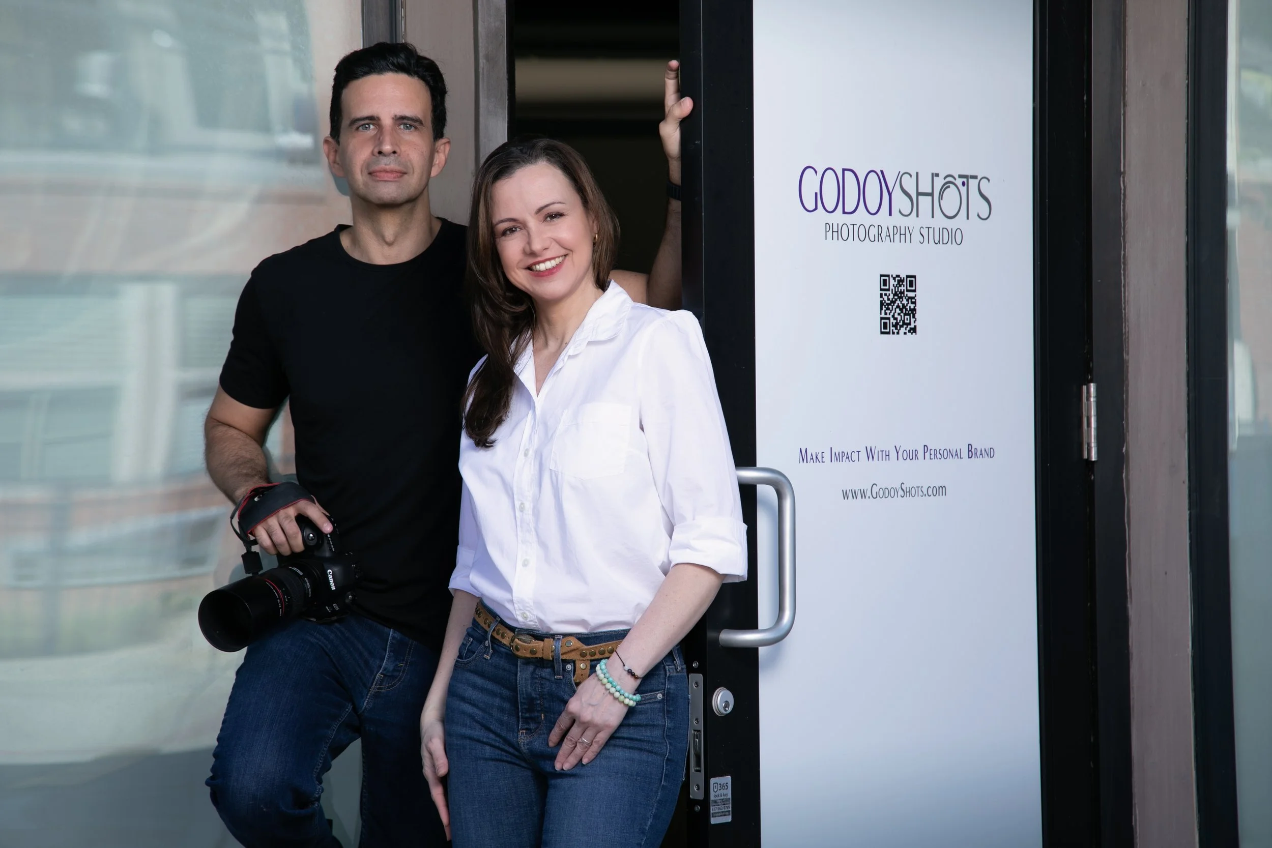 Nabor and Laura Godoy welcoming clients at the Godoy Shots studio entrance in Dallas.