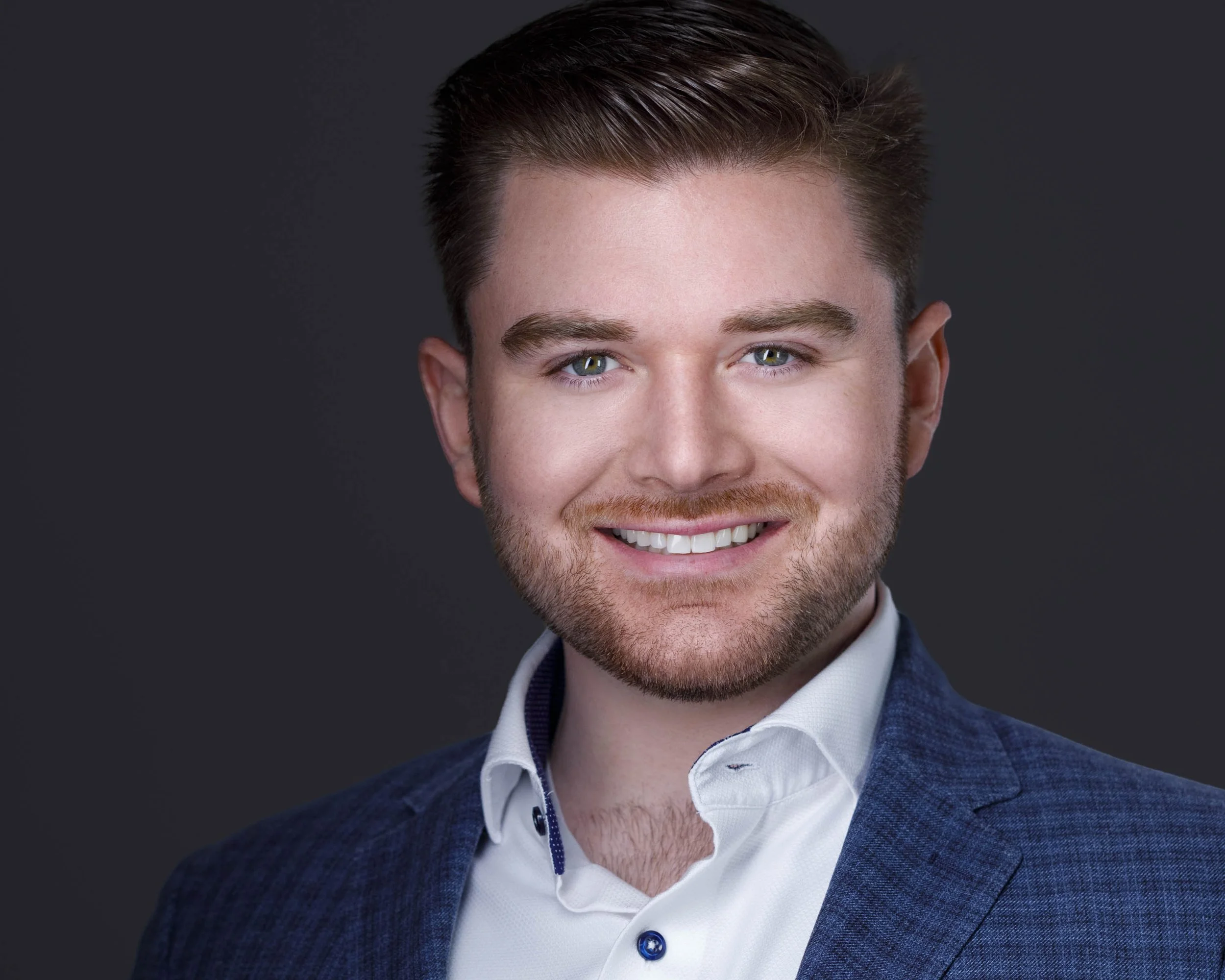 A modern, vibrant business headshot created at Godoy Shots Studio in Dallas, TX. The subtle textured suit, crisp white shirt, and confident expression project both professionalism and approachability. Perfect for entrepreneurs, consultants, and corpo