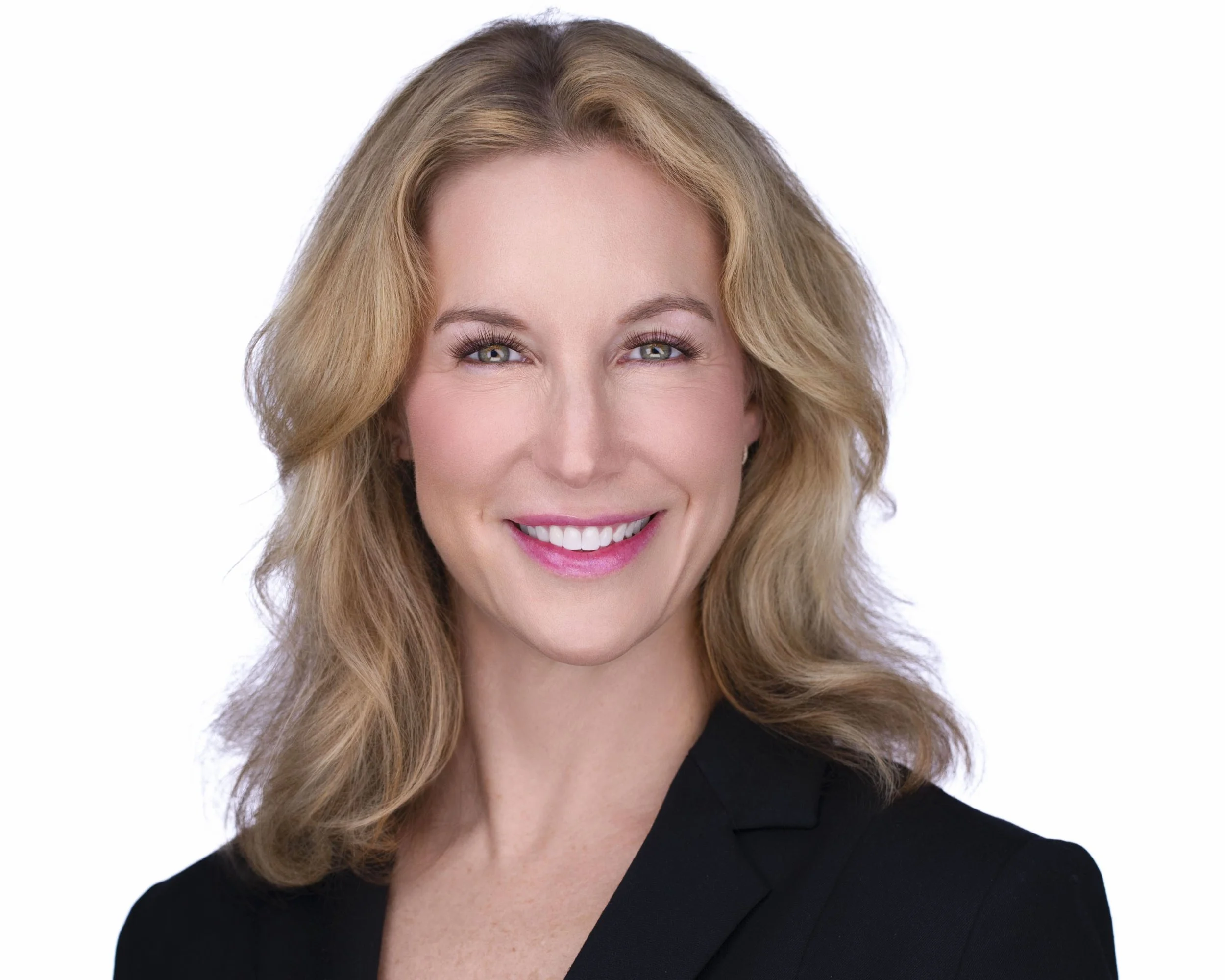 Blonde female executive smiling in studio portrait photographed in Dallas TX.