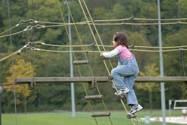 Child climbing on play structure