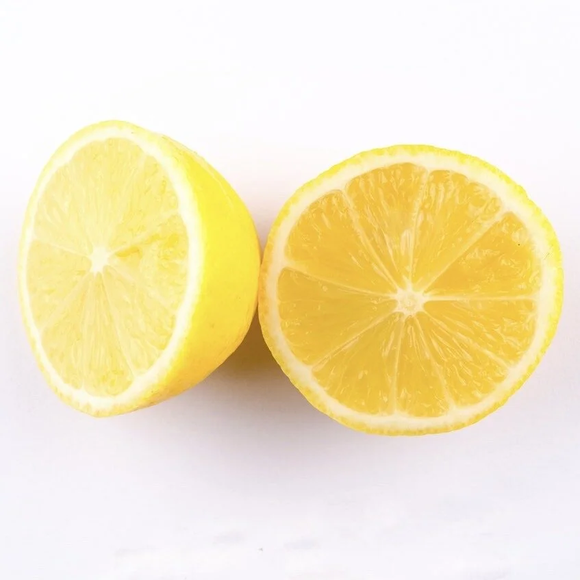 close-up-photo-of-sliced-yellow-lemon-on-white-surface-1414110 2.JPG