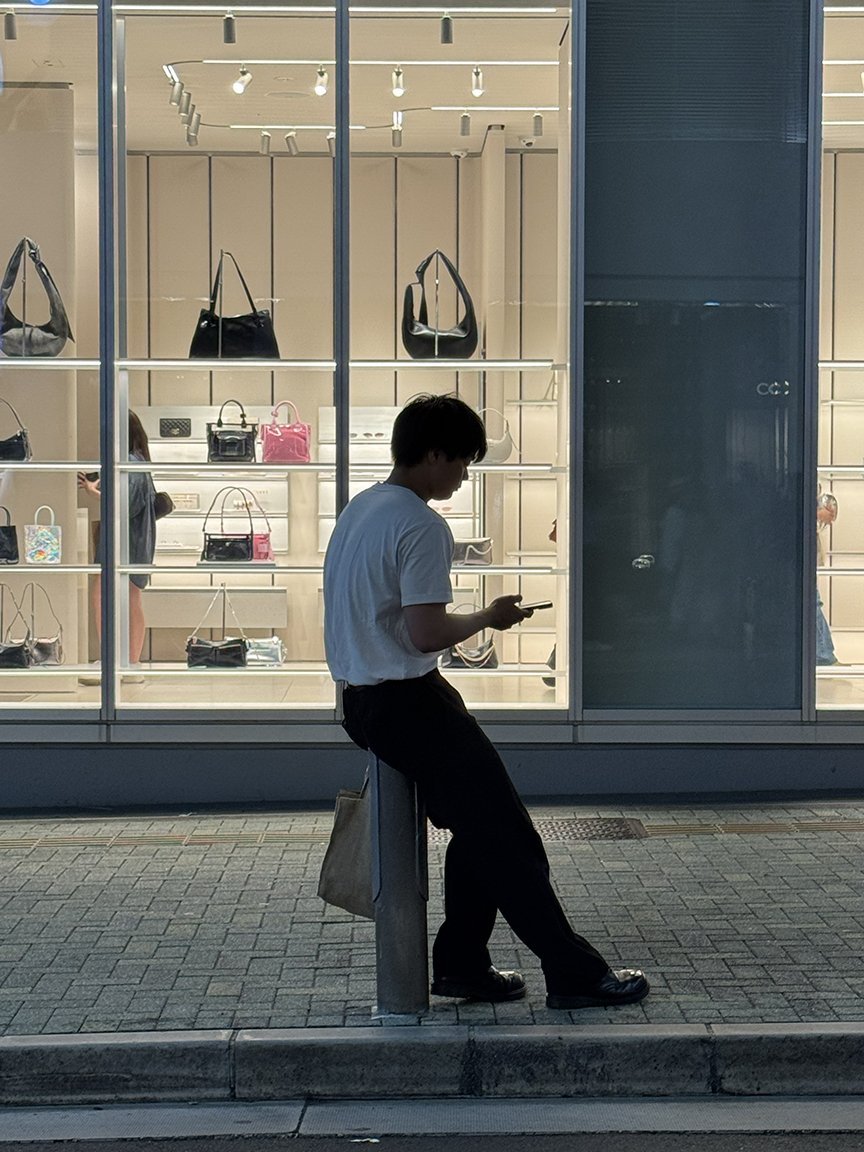 Young man looking at phone, Shibuya, 2025