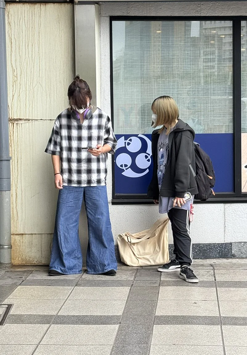 Teenagers looking at phone, Ueno, 2025