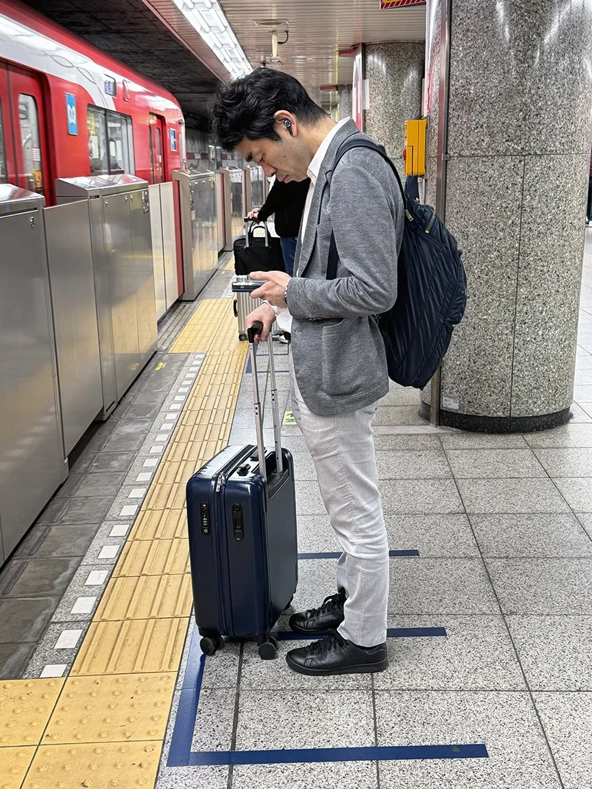 Man looking at phone, Ginza Station, 2025