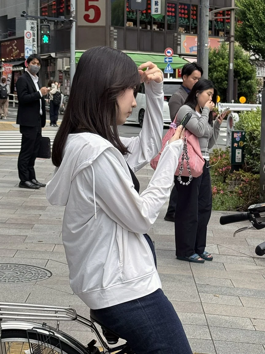Teenager looking at phone, Jimbocho, 2025