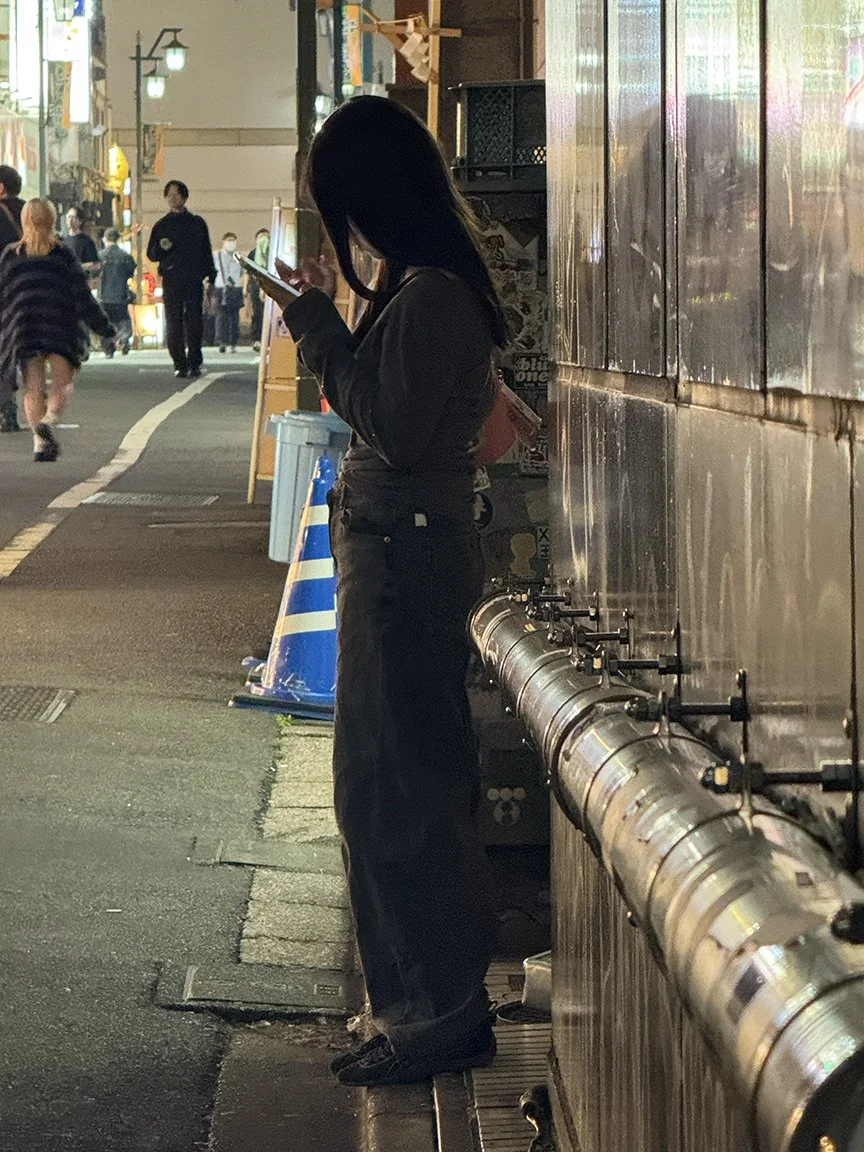 Woman looking at phone, Shinjuku, 2025