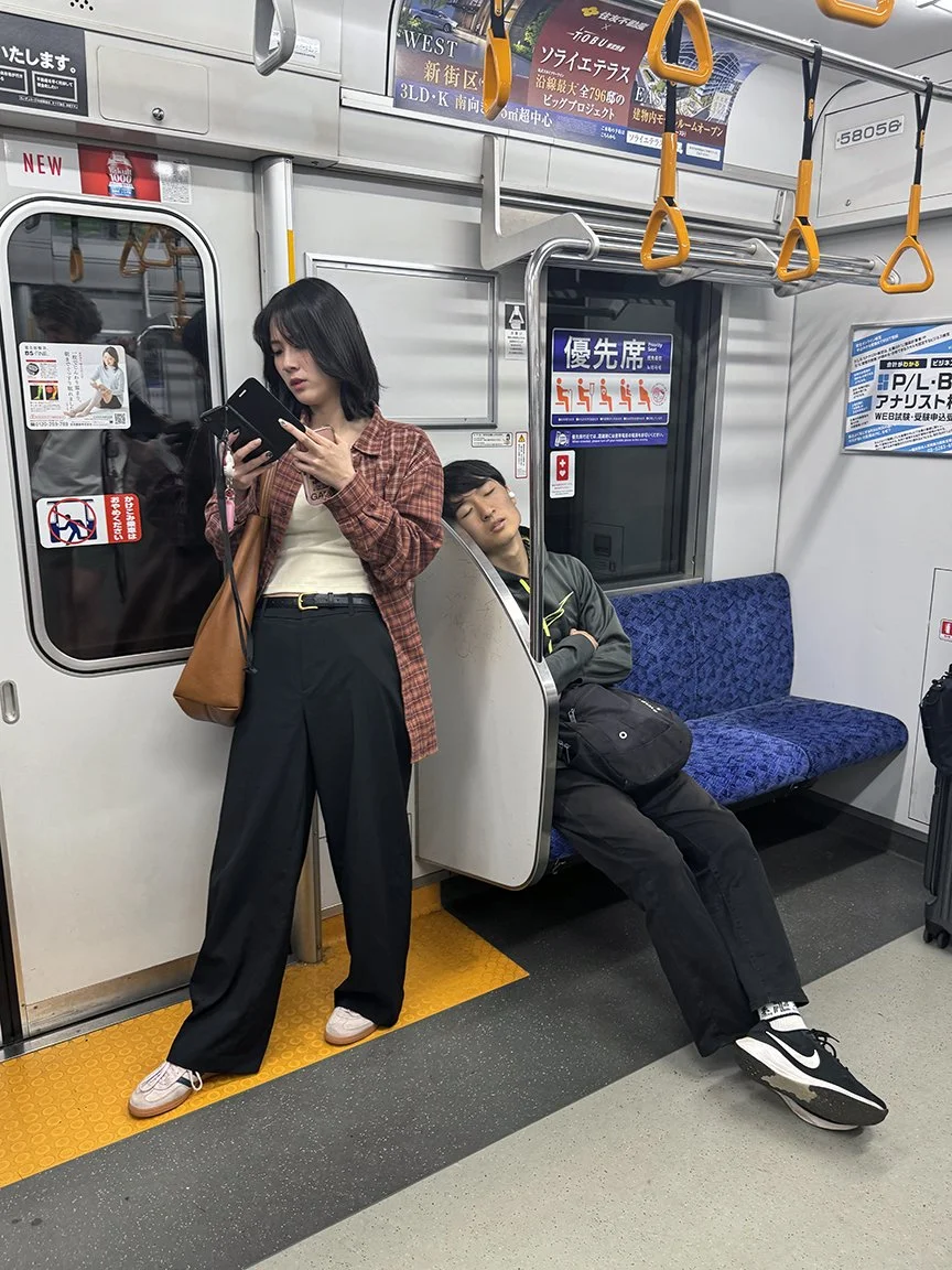 Woman looking at phone, Odakyu Line, 2025