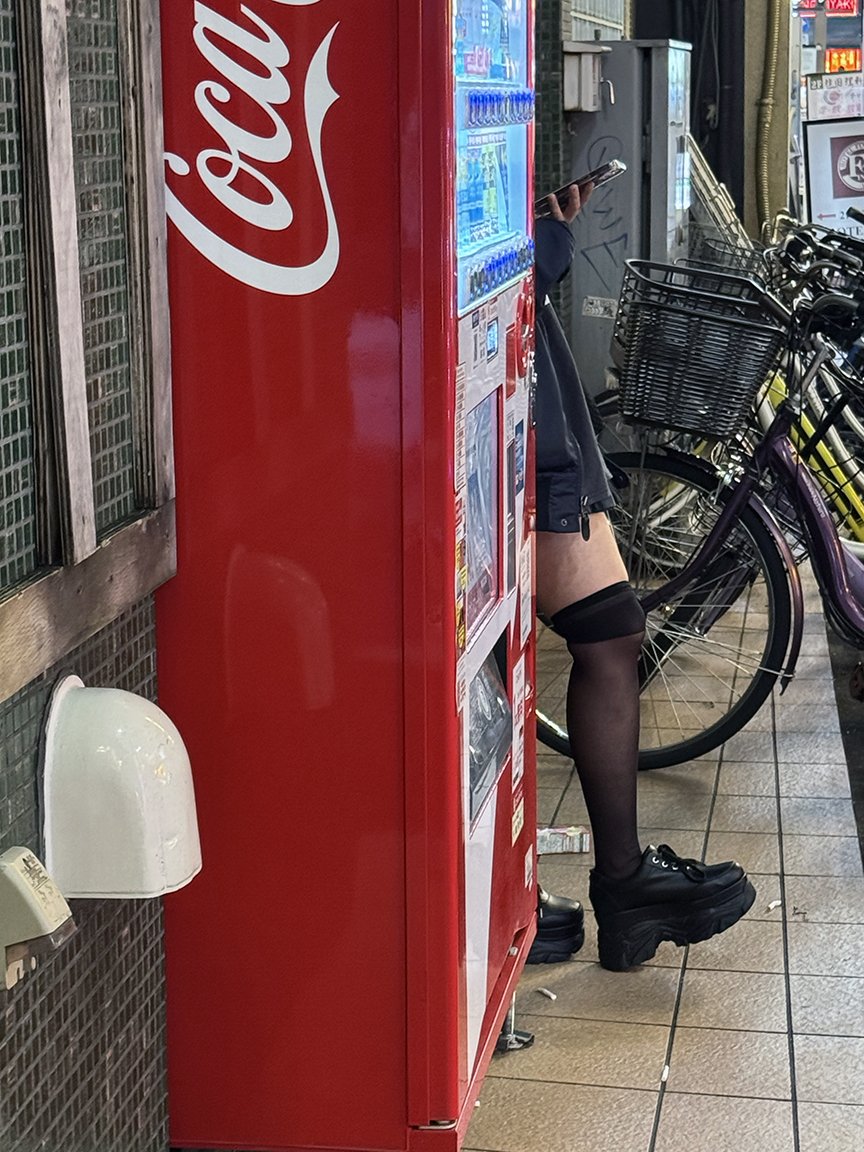Woman looking at phone, Shinjuku, 2025