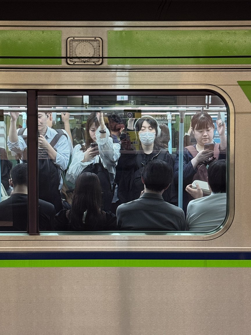 People looking at their phones, Keio Line, 2025