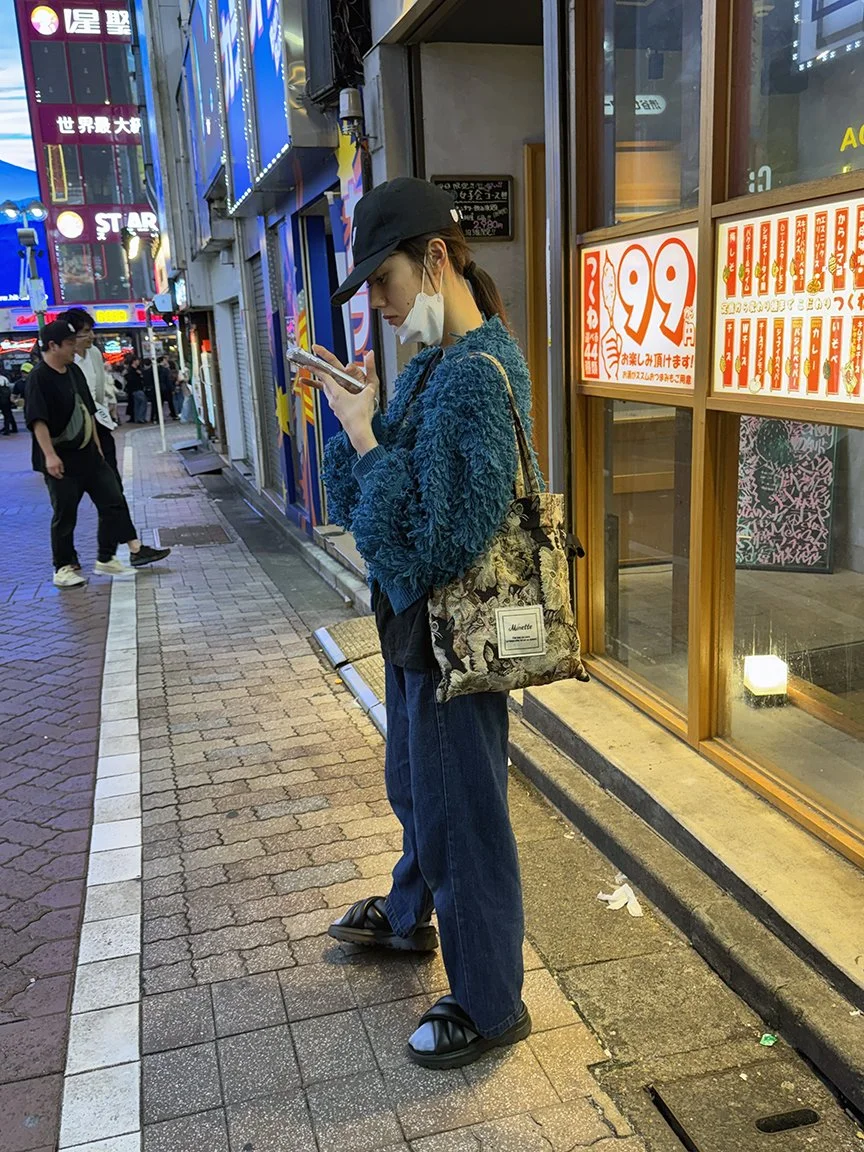 Woman looking at phone, Jimbocho, 2025