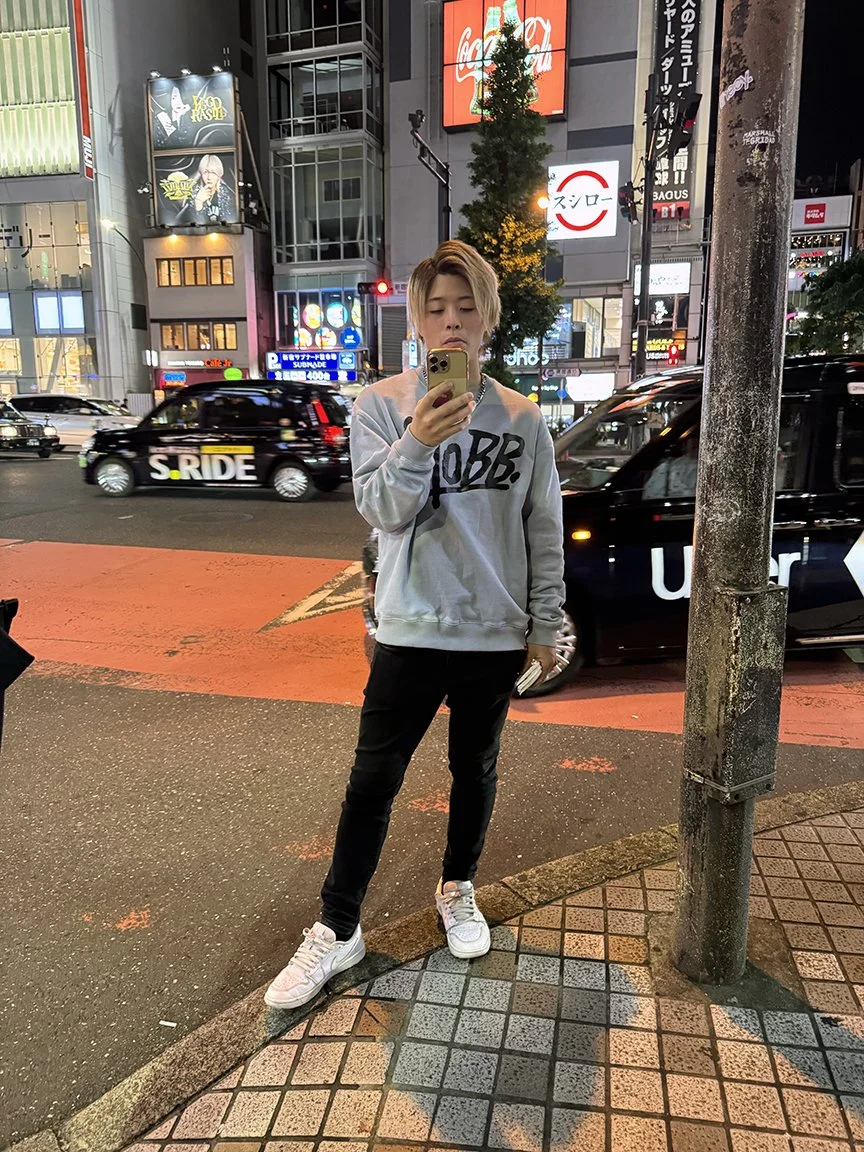 Man looking at phone, Shibuya, 2025