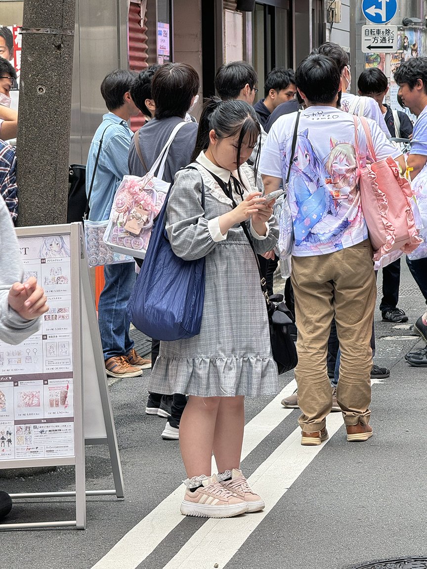 Teenager looking at phone, Shibuya, 2025