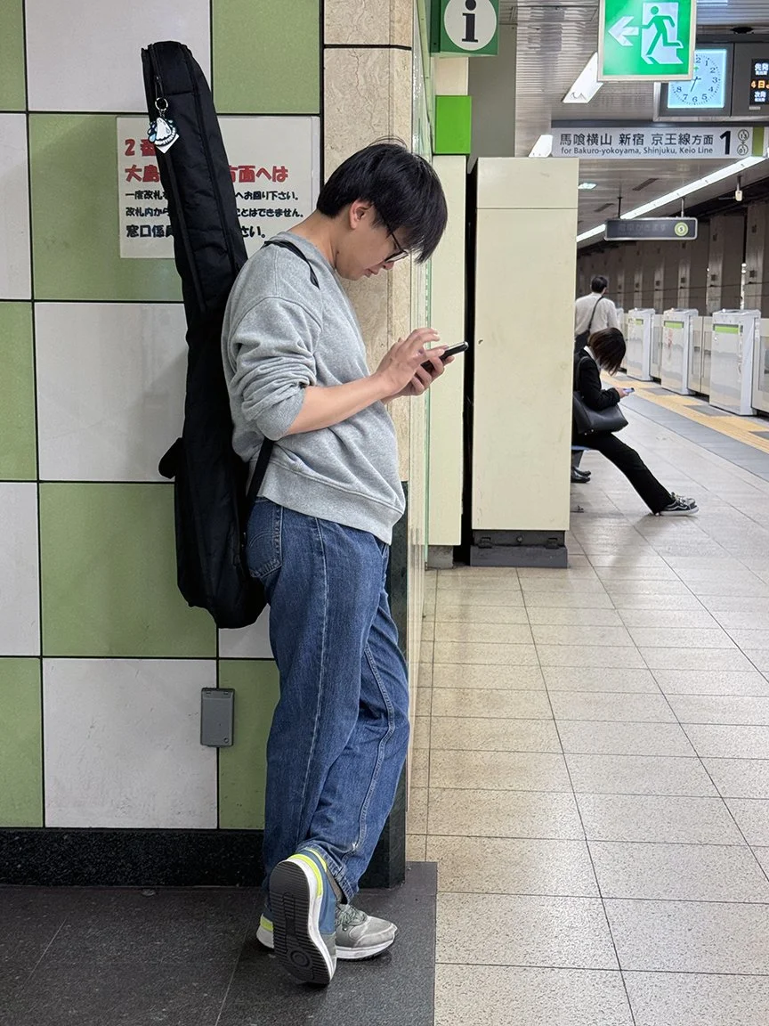 Man looking at phone, Ojima, Station 2025