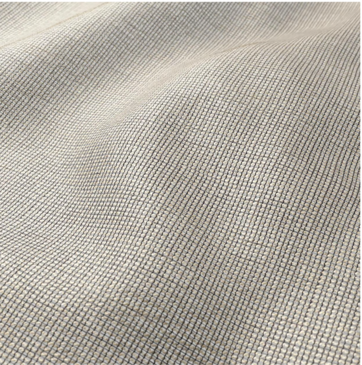 Close-up of beige fabric with a small, dark checkered pattern.