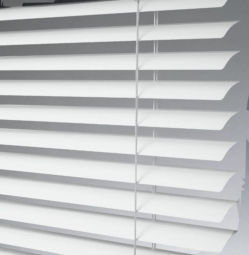Close-up of white window blinds with slats partially open, casting shadows on a light-colored wall.