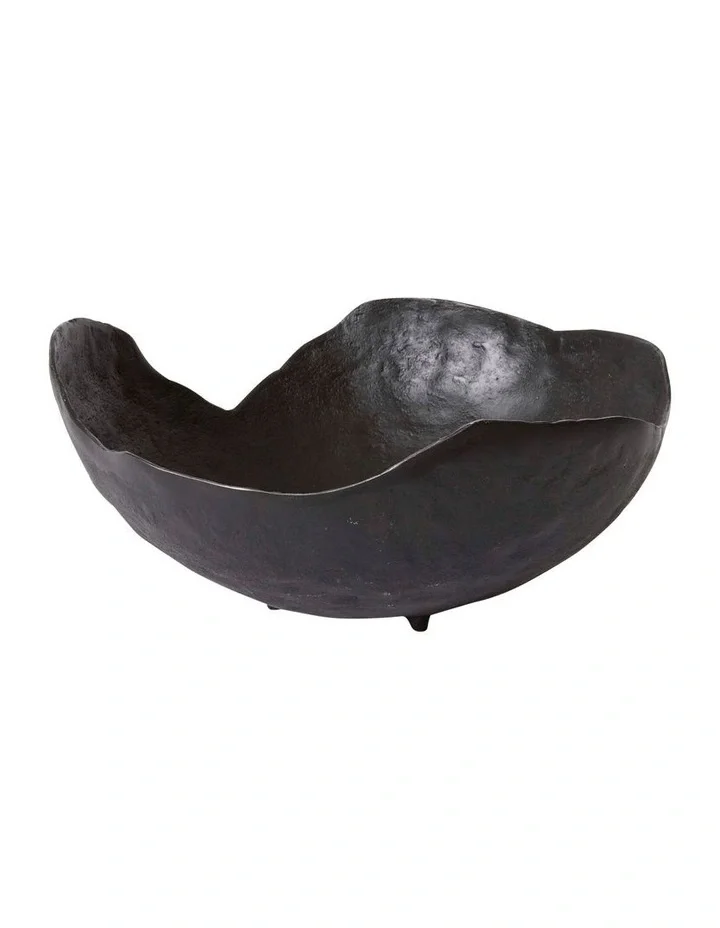 A black, half-sphere shaped sculpture or bowl with a textured surface, set against a plain white background.