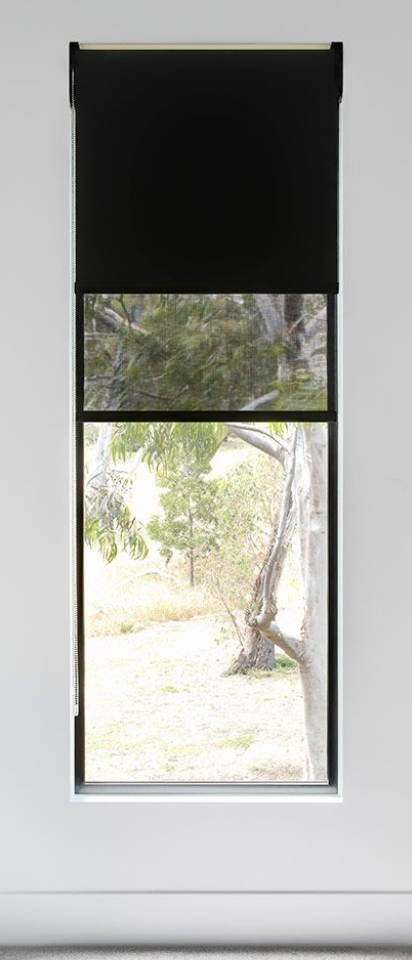 Interior of a living room with a gray sofa, yellow cushions, a yellow blanket, a white table with potted plants, large window with patterned blinds, and artwork of stylized flowers on the wall.