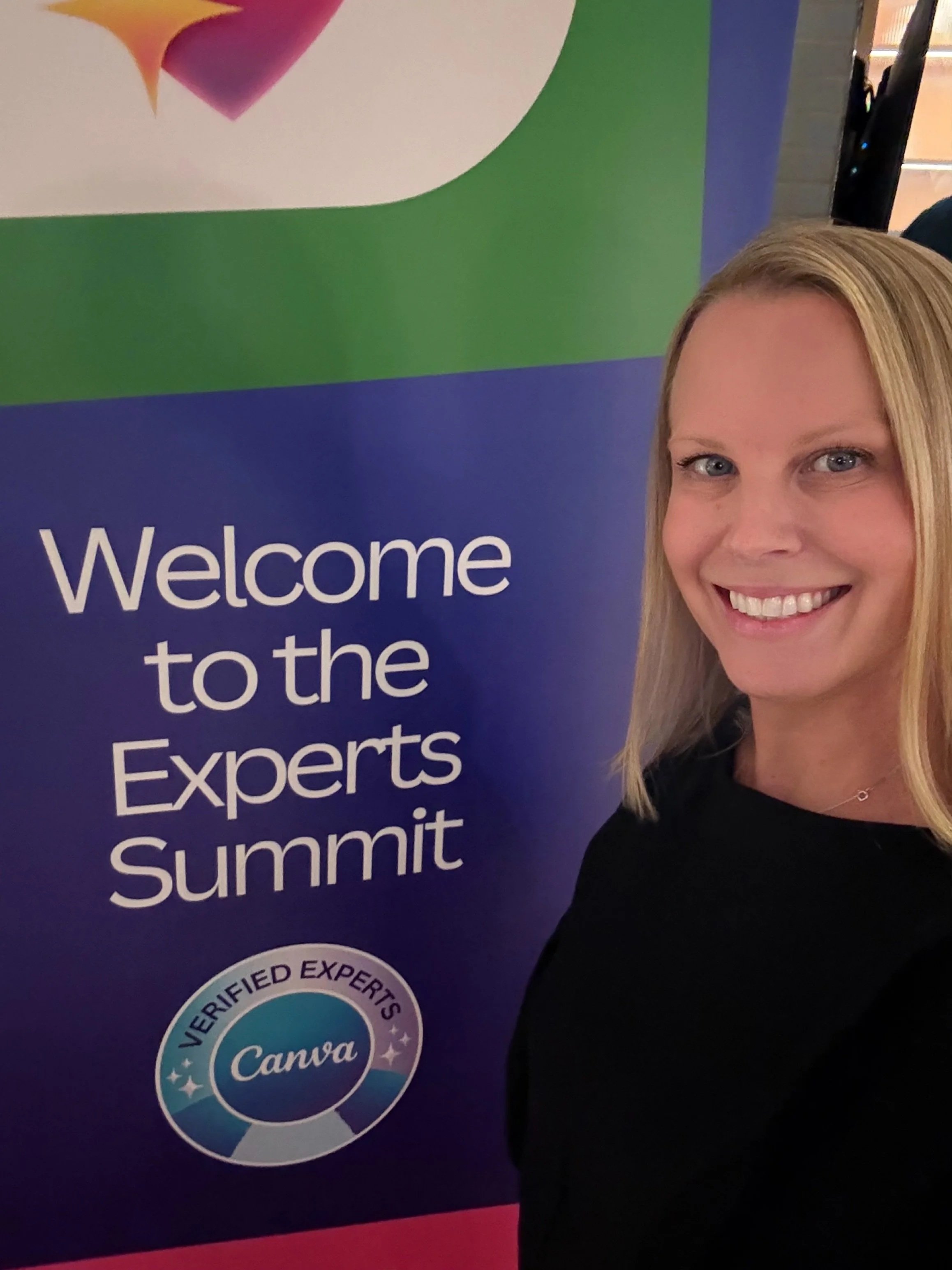 Rebecca Flint, a smiling woman taking a selfie at a professional event with a banner in the background that reads 'Welcome to the Experts Summit' and features a colorful logo.