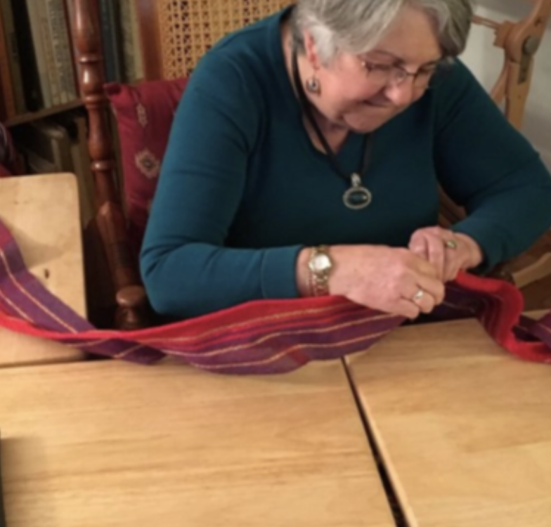 Master weaver, Martha Decherd, creating accent from colors in torah text