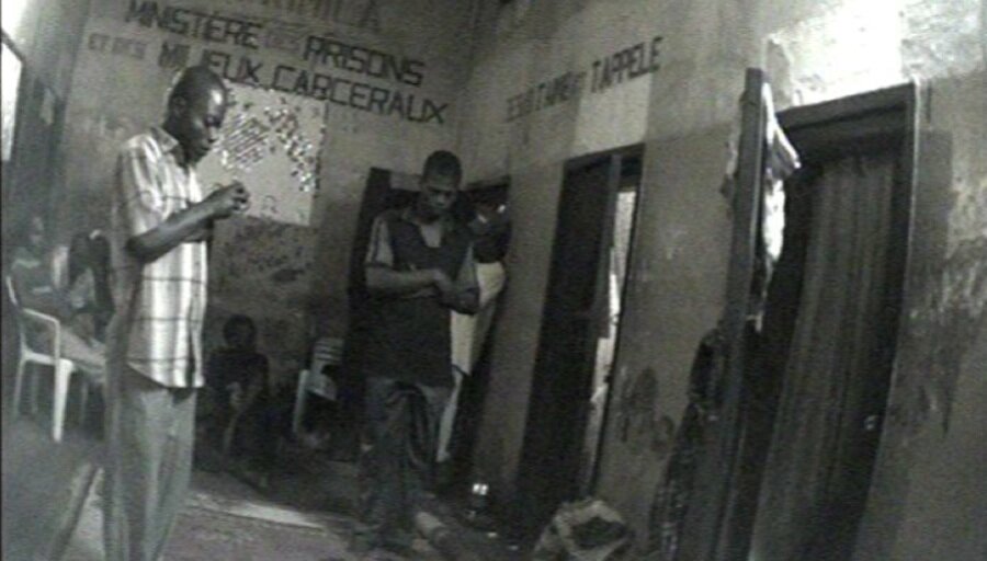  Prisoners pray in a corridor 
