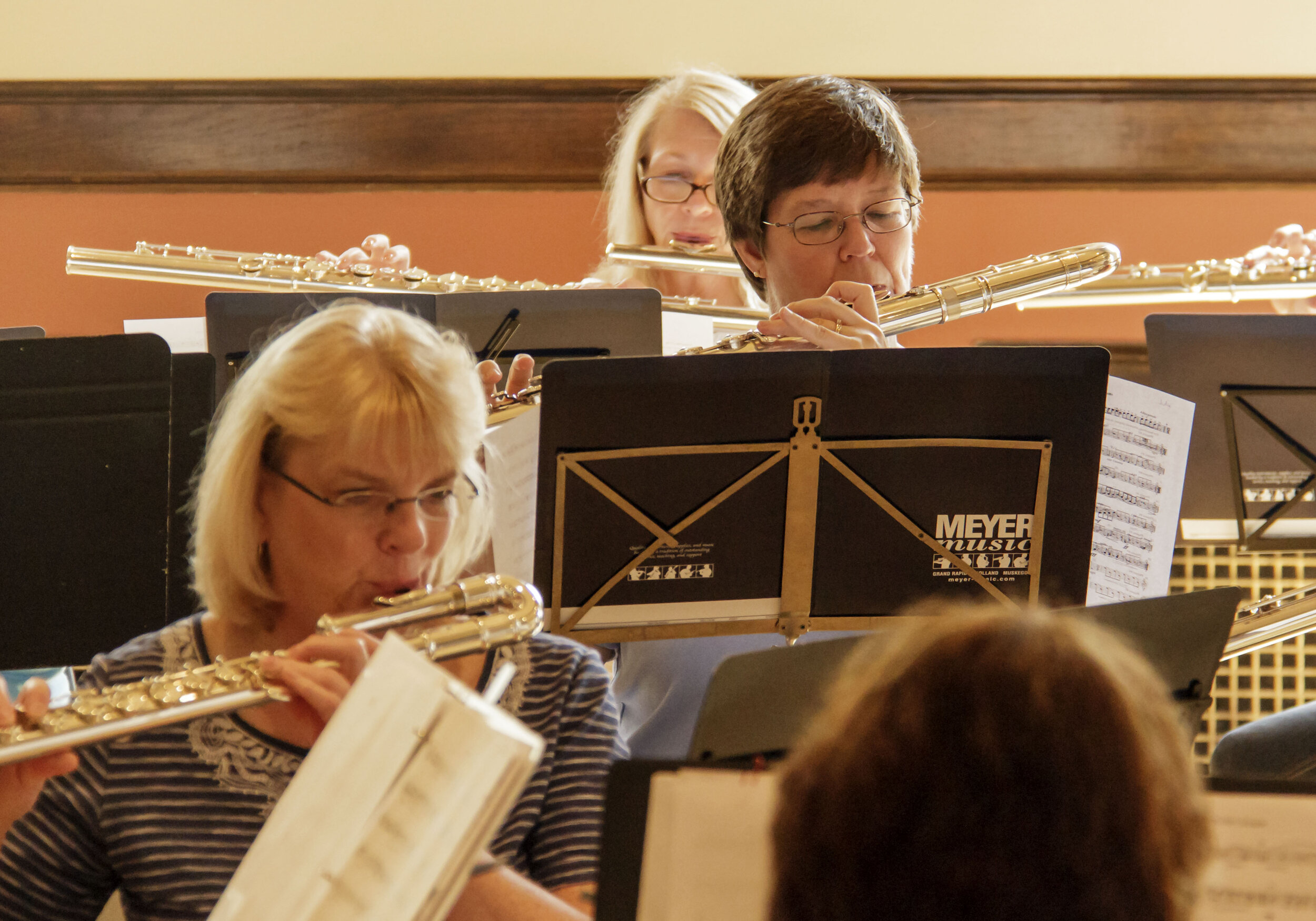 Members playing alto and bass flutes