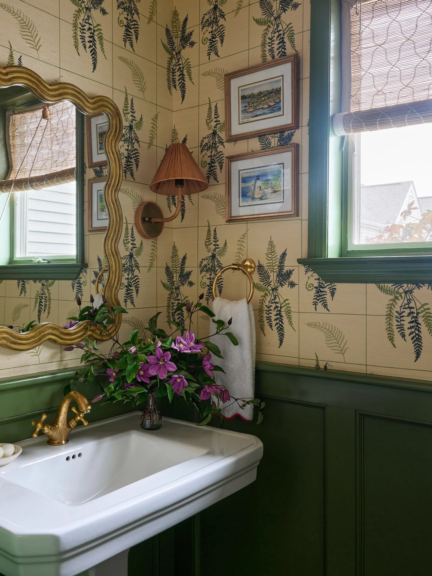 Behind this jewel box powder room renovation. 

Inspired by our years living in Newport, I wanted this small space to feel like a slice of New England. I wrapped the walls in an embroidered botanical and carried the green across the millwork for a fu