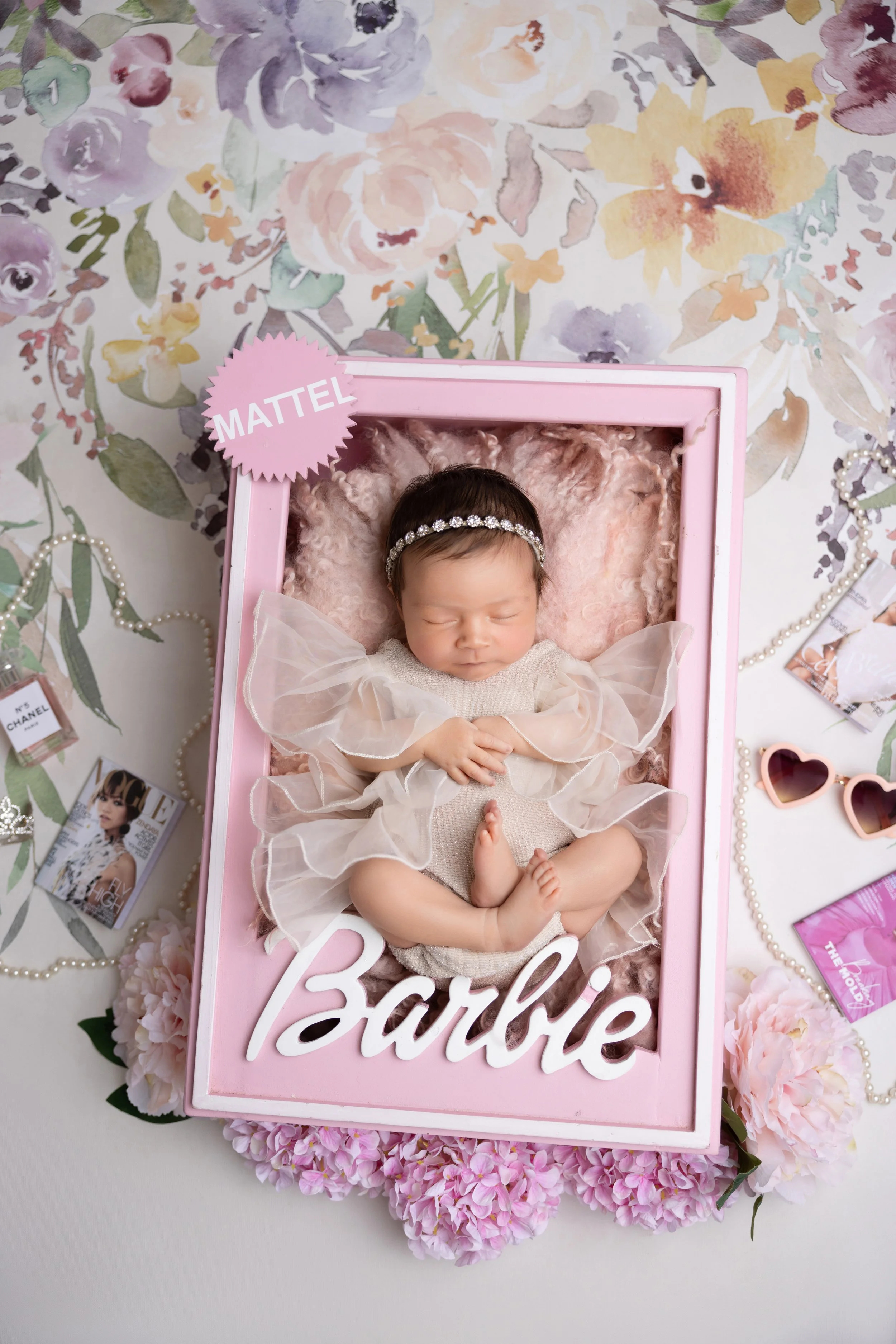 Barbie Theme Newborn Photo
"Creative Barbie-themed newborn session in Los Angeles — baby girl styled as a real-life doll inside a custom Barbie box with pink florals and chic details.