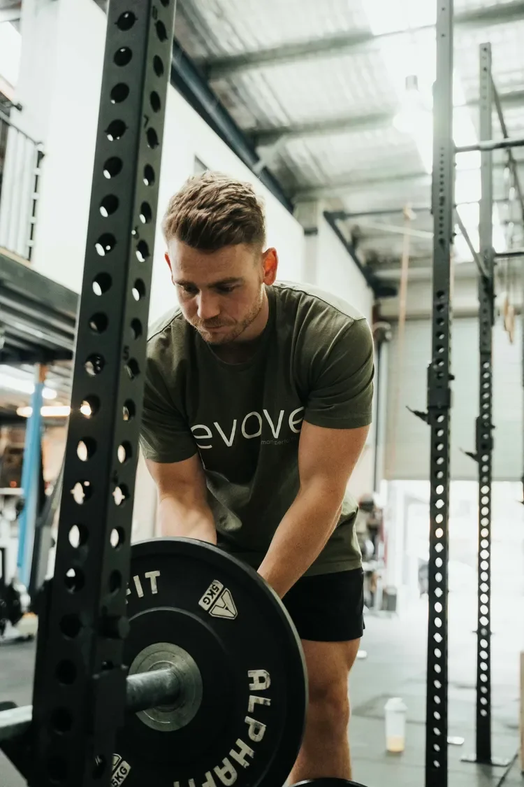 Man loading barbell in a gym