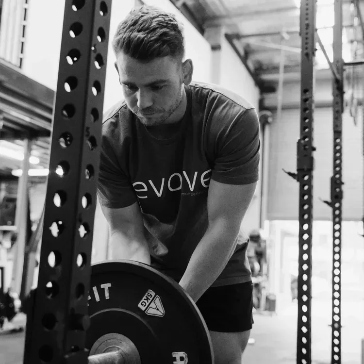 A man loading a barbell in a gym in Caringbah Sutherland Shire