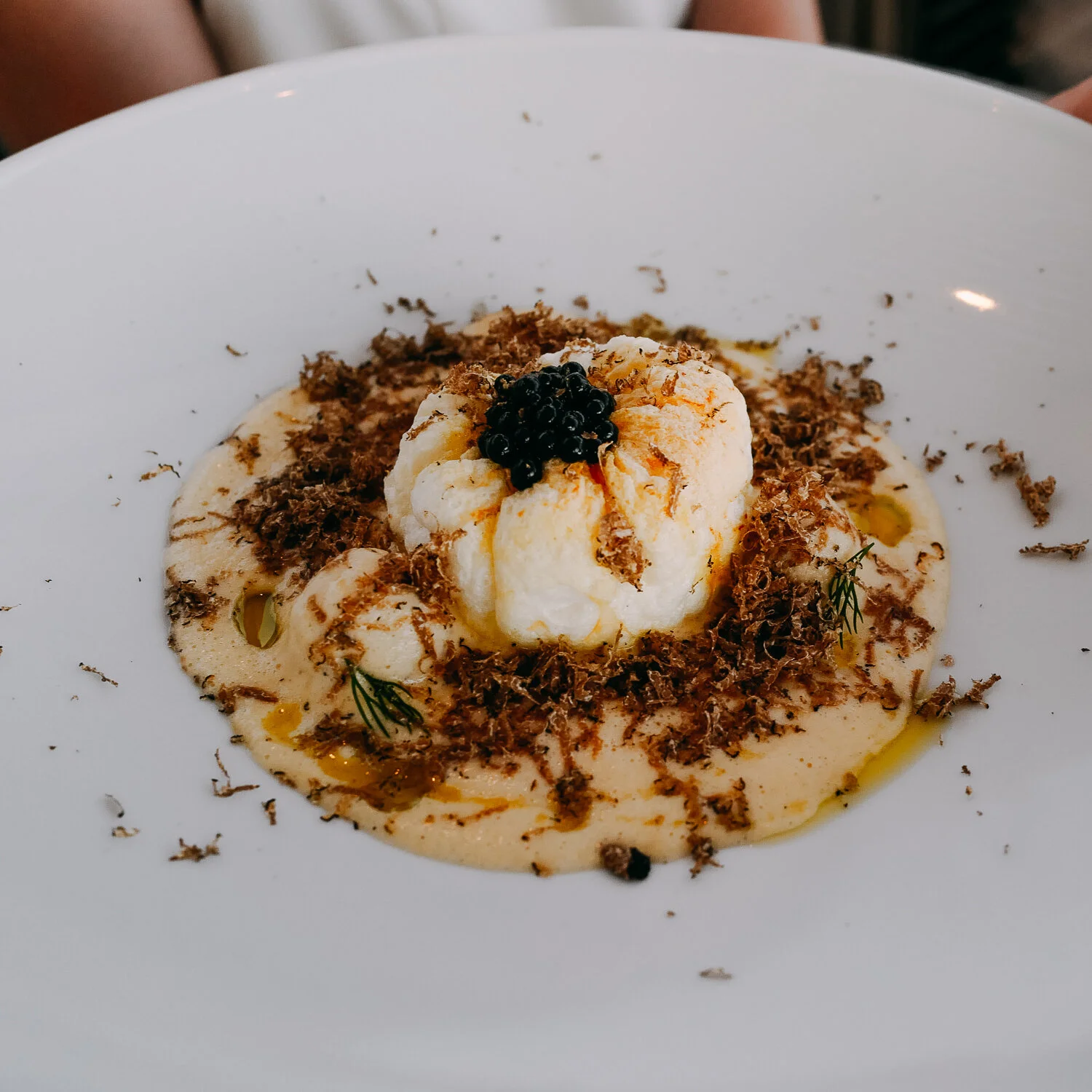EGG & LEMON BOMB. Rooster yiouvarlakia, egg soufflé, truffle pearl.