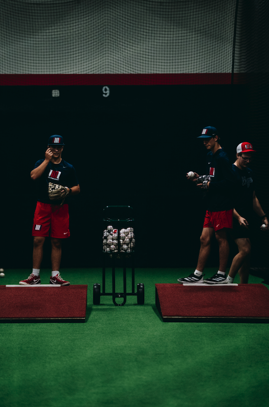 Pitchers throwing from indoor mounds during Northwest Nationals Development Academy practice