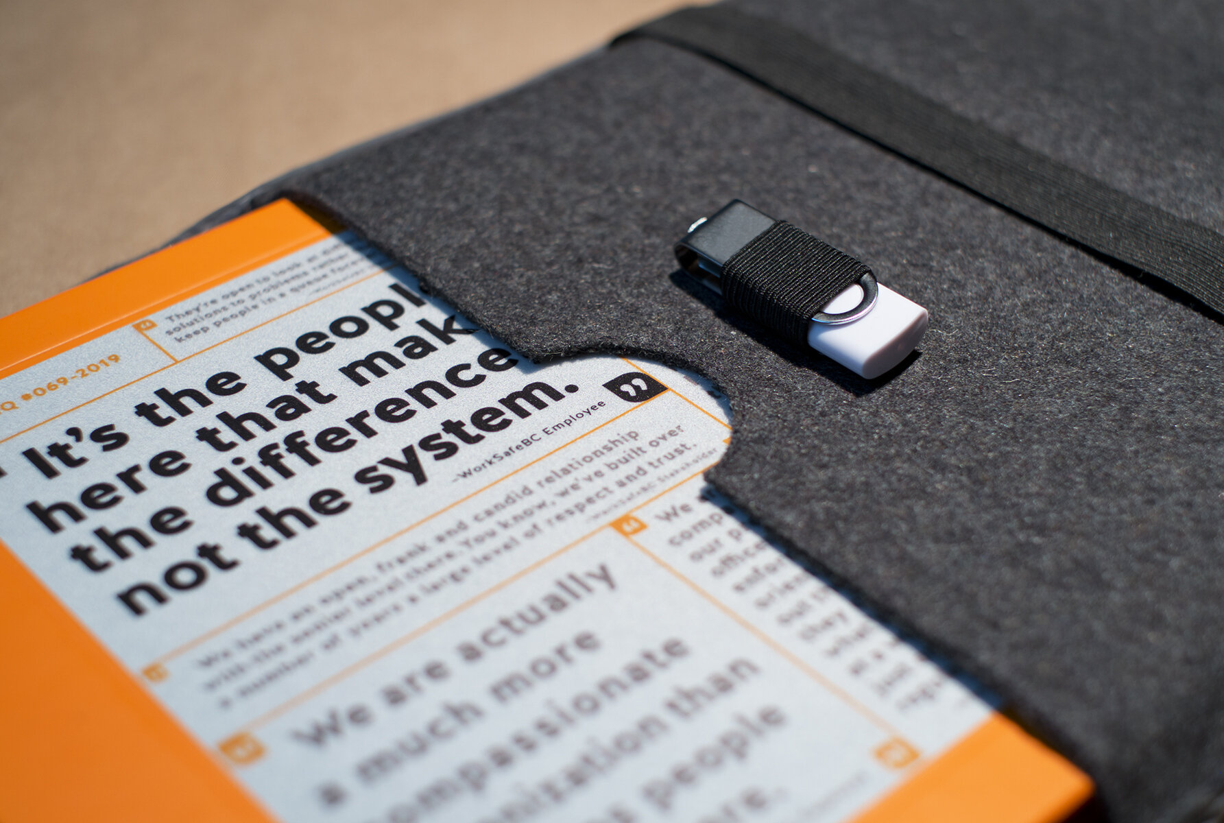  Closeup of orange brochure with flash drive 