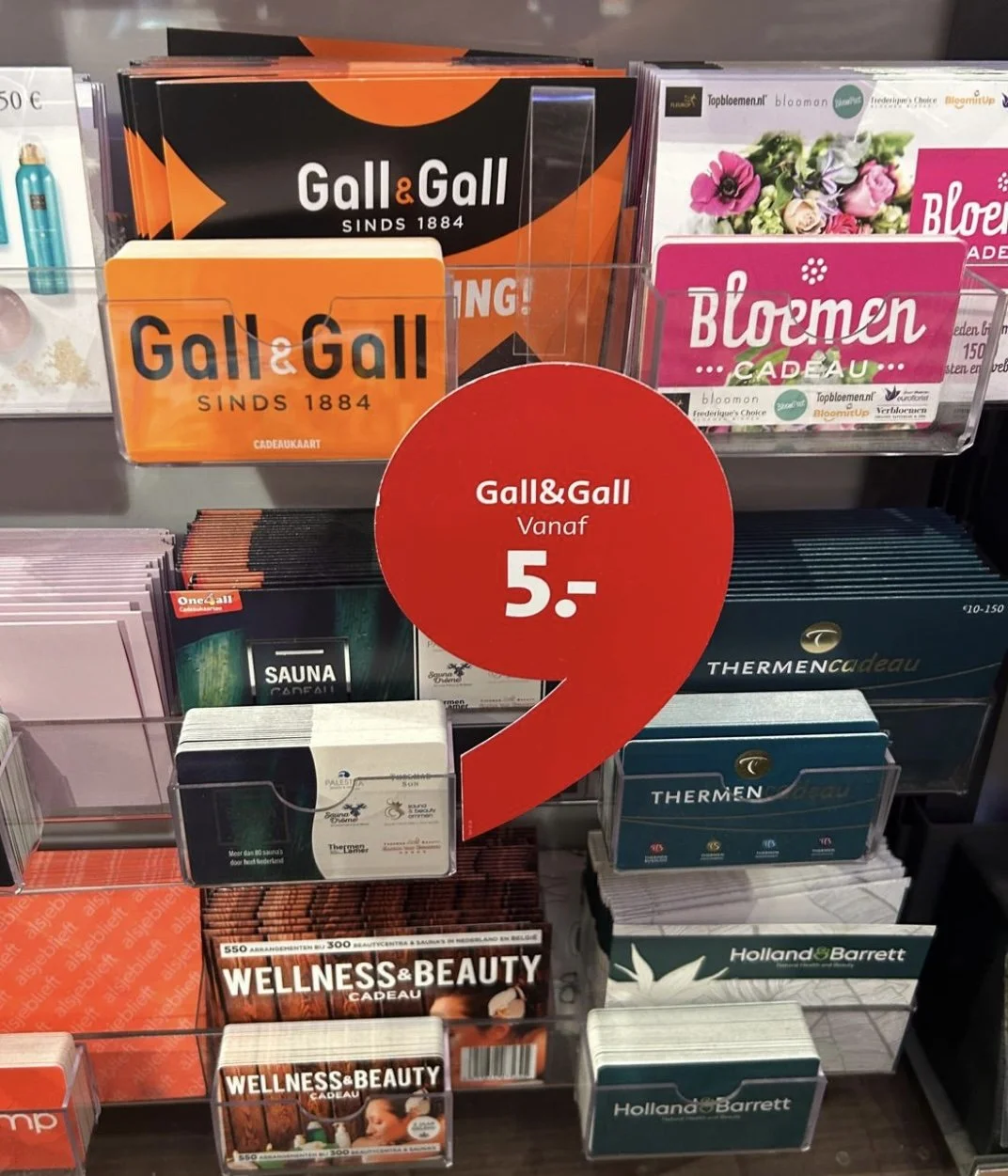A display of gift cards for various stores and services, with a red sign indicating all Gall & Gall gift cards are priced from 5 euros.