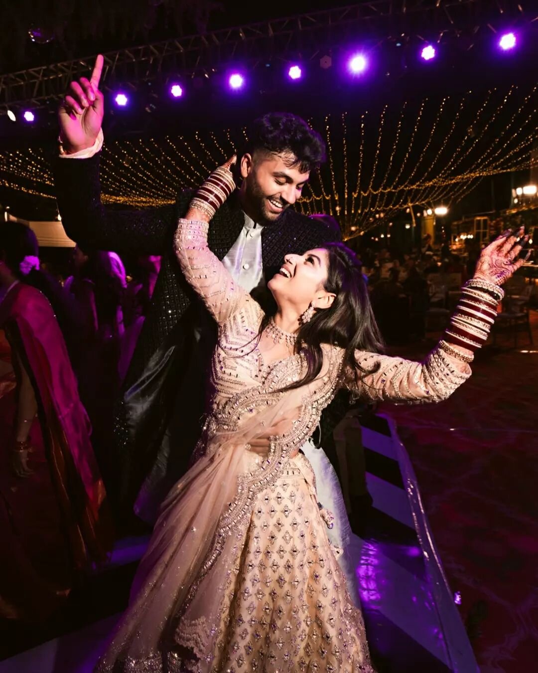 Grab your cocktail shakers and put on your dancing shoes because Snehal and Umang's Sangeet cum Cocktail party is in full swing! 🥂

The venue is transformed into a glamorous hotspot, with lights twinkling like stars in the sky and cocktails served i