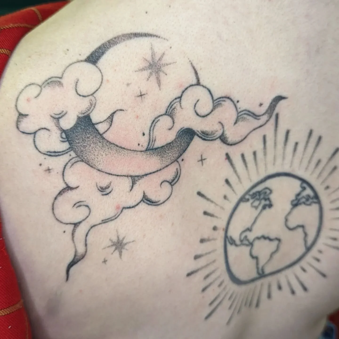 #handpoked back in progress on a wonderful person 🥰 the globe was done by another artist but needed some spicing up - we have added the sun rays &amp; this big beautiful celestial moon design on one shoulder, with plans for the rest of the back! for