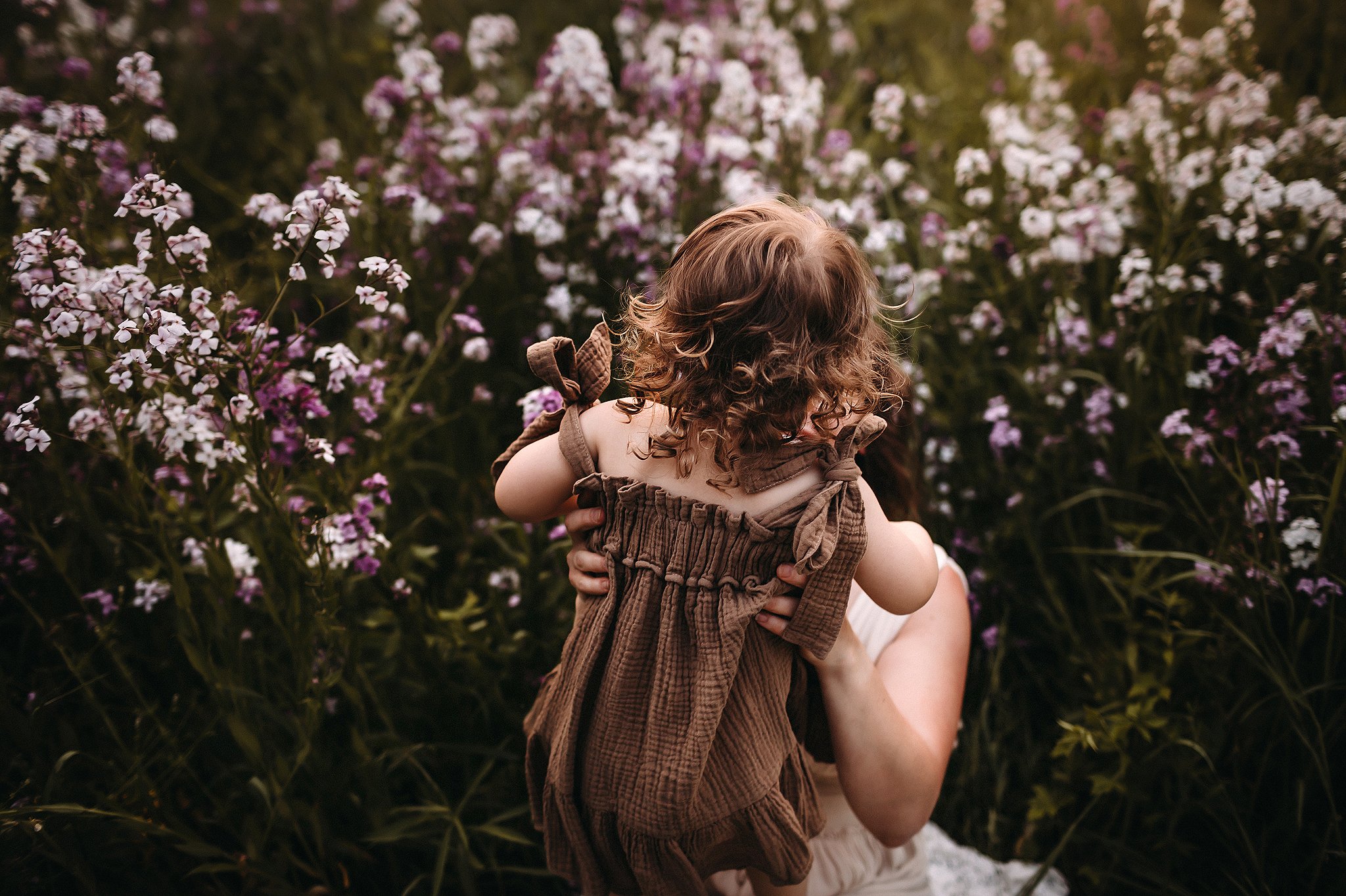 Little girl dancing in field of flowers