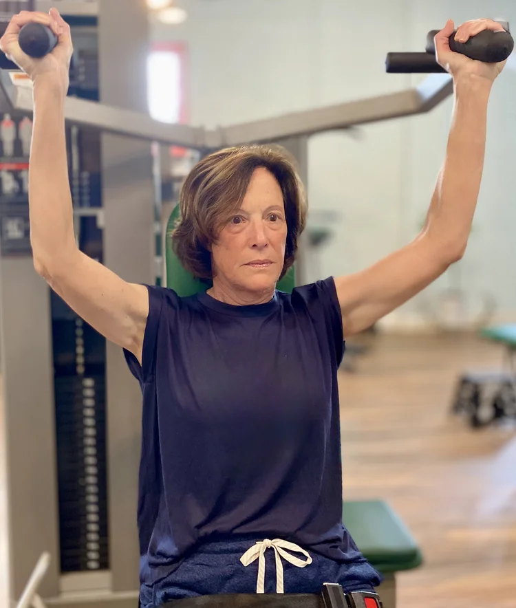 Access Strength client doing an overhead press