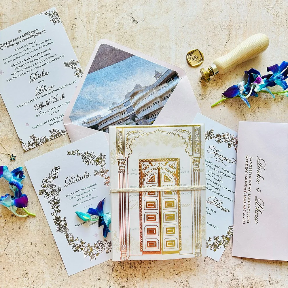 Elegant luxury Indian Wedding invitation suite with shimmering gold foil accents and custom bespoke design elements.