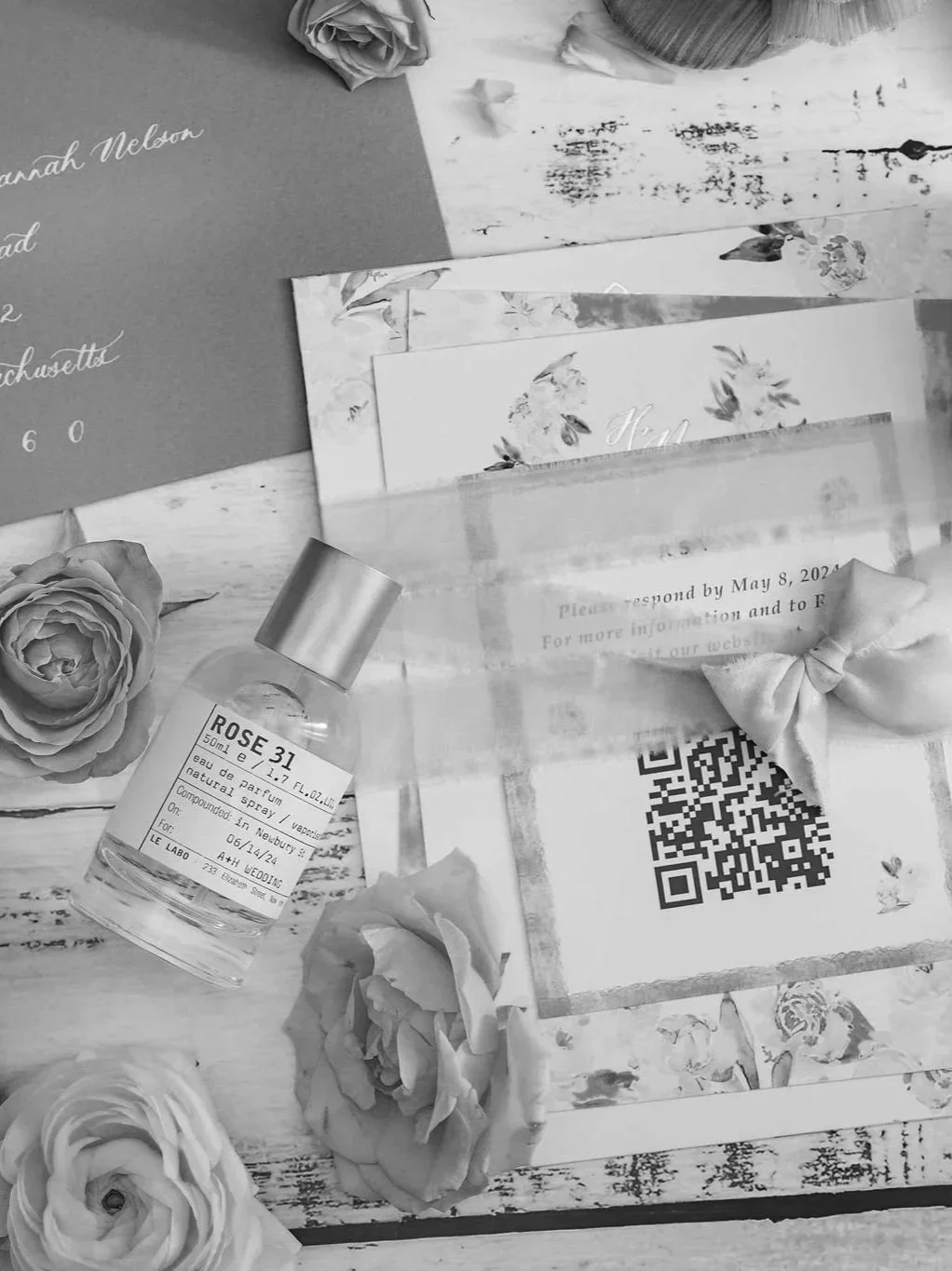 Close-up of a luxury Chicago wedding invitation featuring a ribbon and QR code.