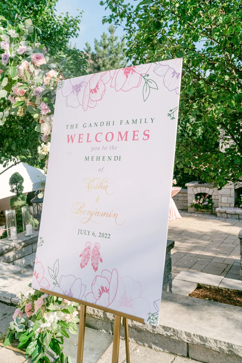 A bespoke welcome signage for a Mehendi ceremony with pastel florals to match the decor.