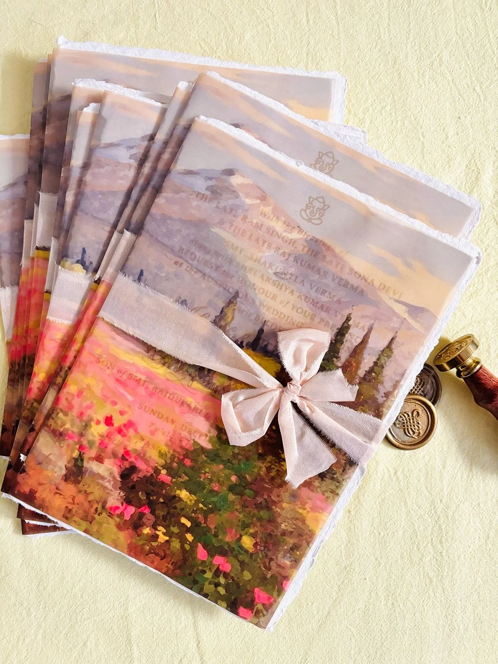 Macro view of vellum folder for a bespoke luxury wedding in the mountains, showcasing  hand torn luxury silk ribbon.