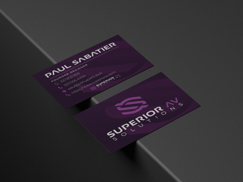 Close-up of two dark purple business cards for Superior Solutions, one showing the logo and the other with contact details, on a black surface.
