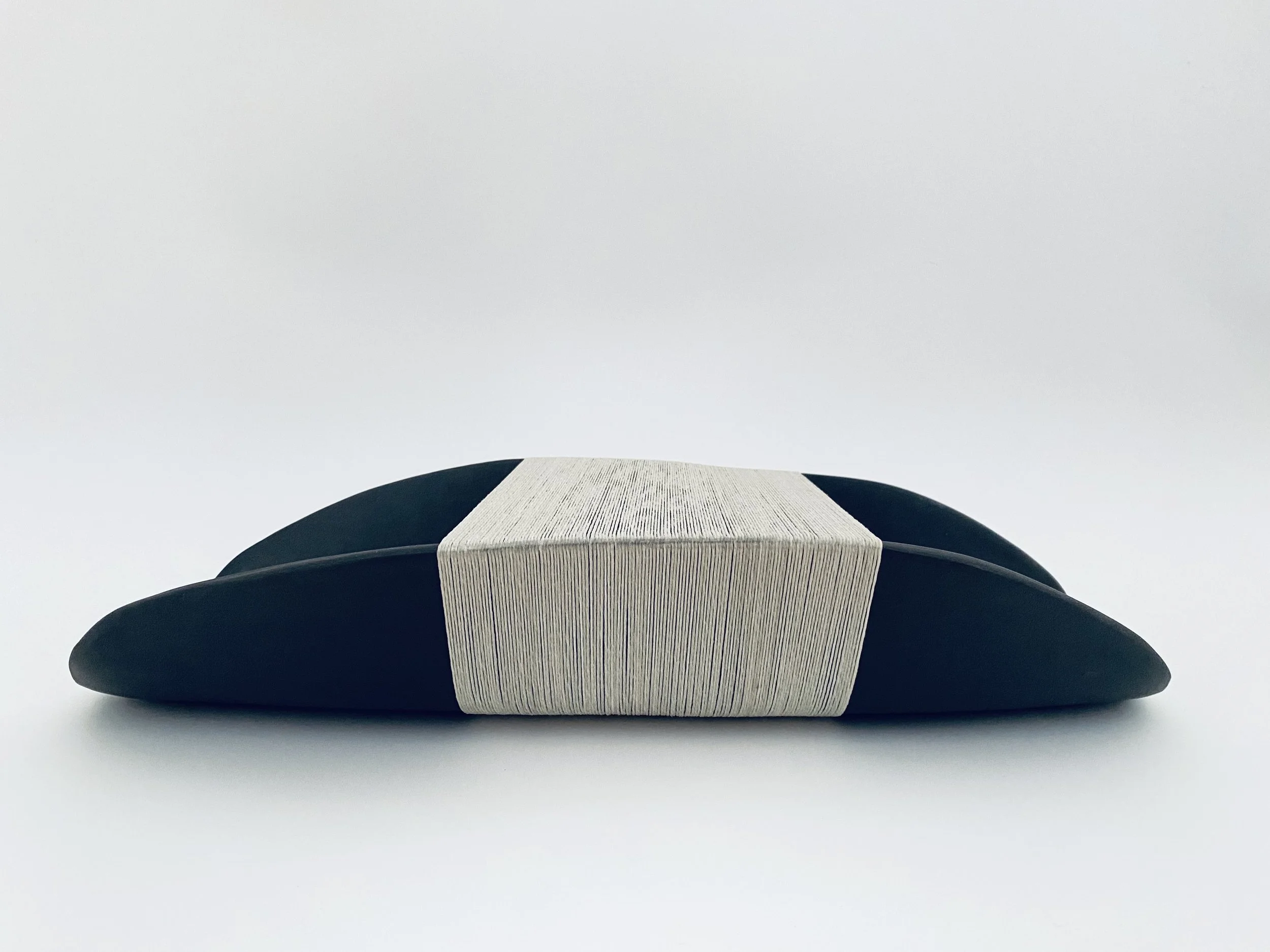 In My Arms, black porcelain and waxed polyester thread, 2025.