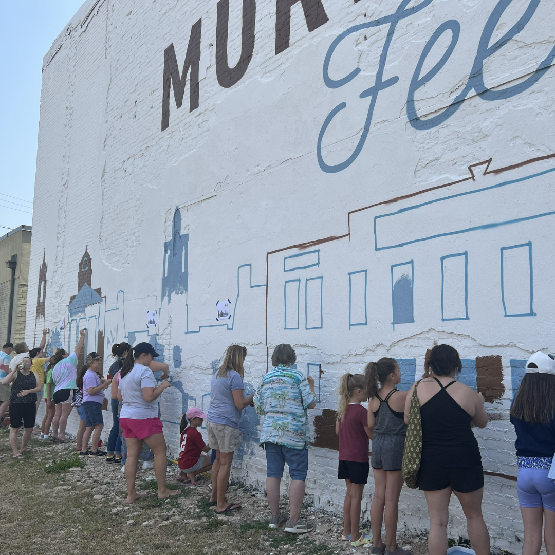 Kids helping paint mural