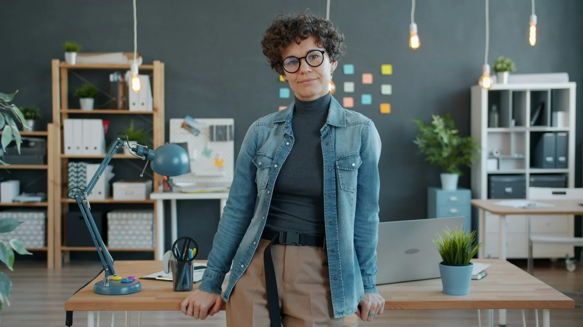 woman leaning infront of a desk